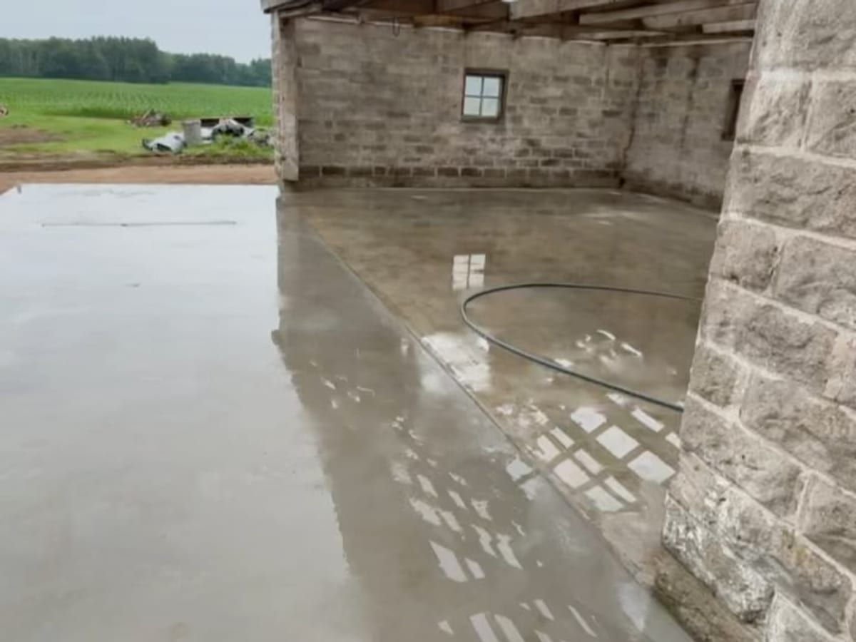 New concrete floor curing inside an old barn